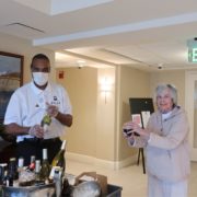 photo of a Roland Park Place staff member serving wine to a senior resident