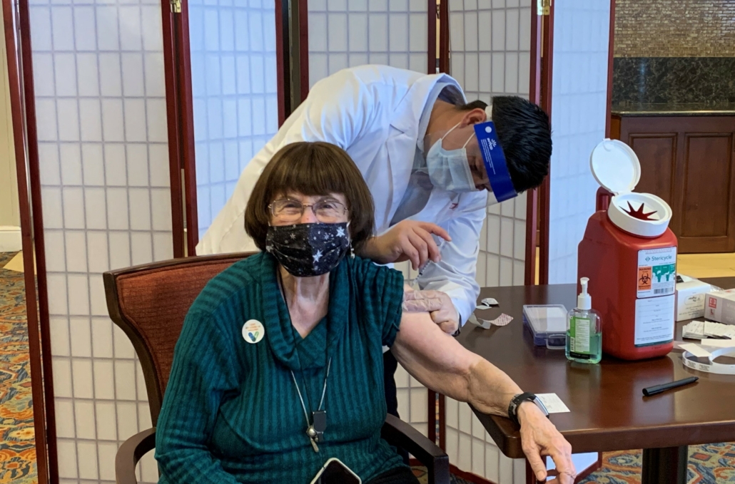 photo of Lois Ernst, a resident at our senior community, getting a vaccination