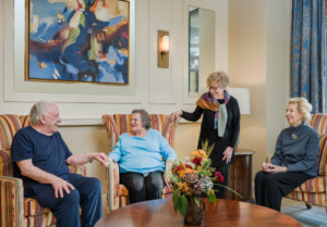 four senior living residents talking together