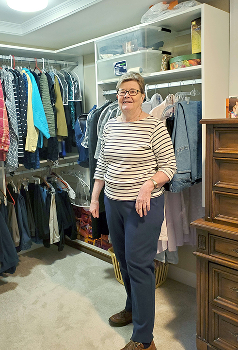 Image of a Roland Park Place resident standing inside her large closet.