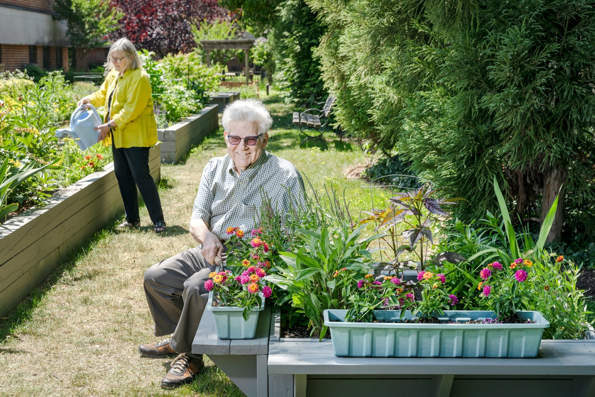 Two seniors enjoying an outdoor garden