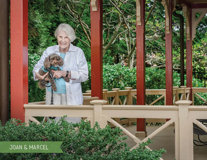 senior resident and her dog posing for a photo at Roland Park Place, Baltimore senior living